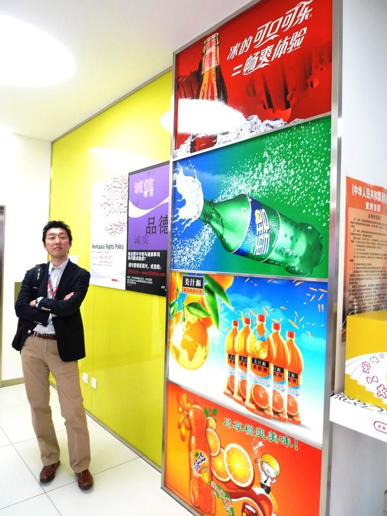 In this picture I can see there is a man standing and he is wearing a blazer and on to right there...